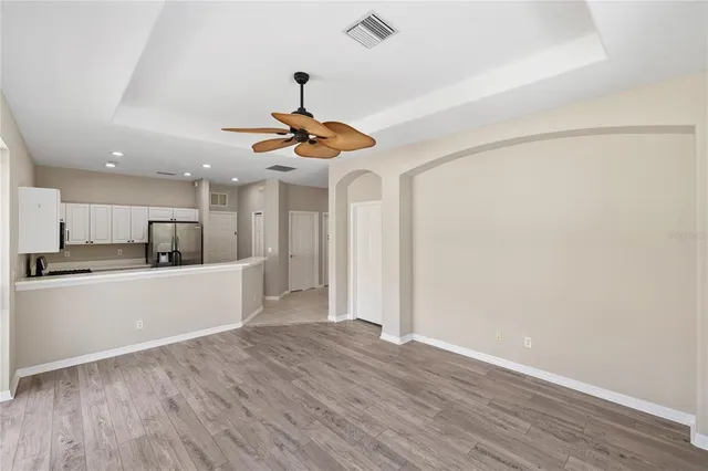 a view of kitchen with stainless steel appliances refrigerator stove microwave and cabinets