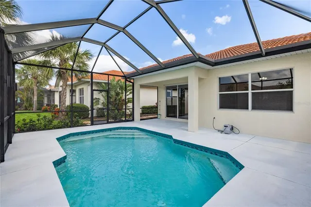a kitchen with stainless steel appliances a refrigerator sink and white cabinets