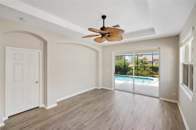 a view of a livingroom with a fan & a ceiling fan