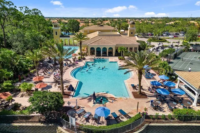 an aerial view of a house with a yard and lake view
