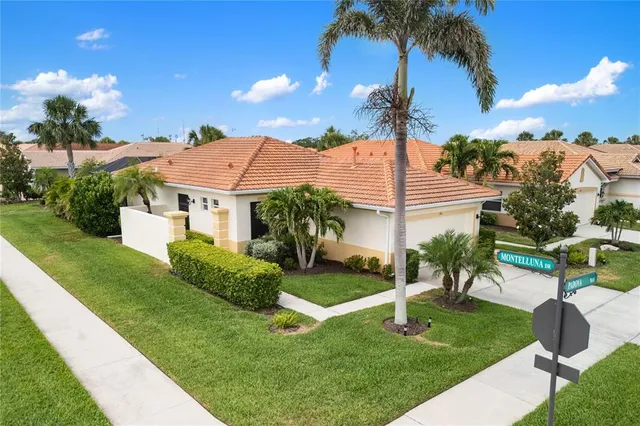a view of a house with a yard and a garden