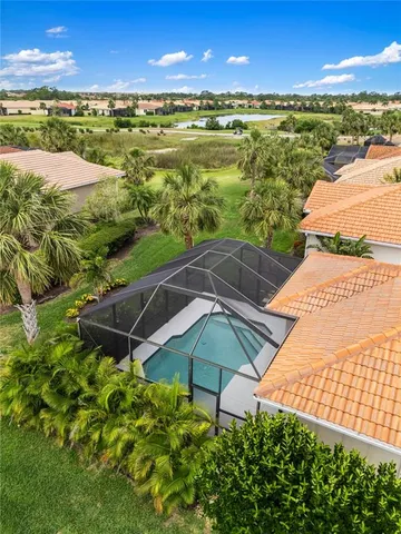 a kitchen with stainless steel appliances granite countertop a dining table and chairs