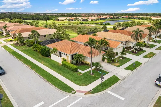 an aerial view of residential houses with outdoor space and river