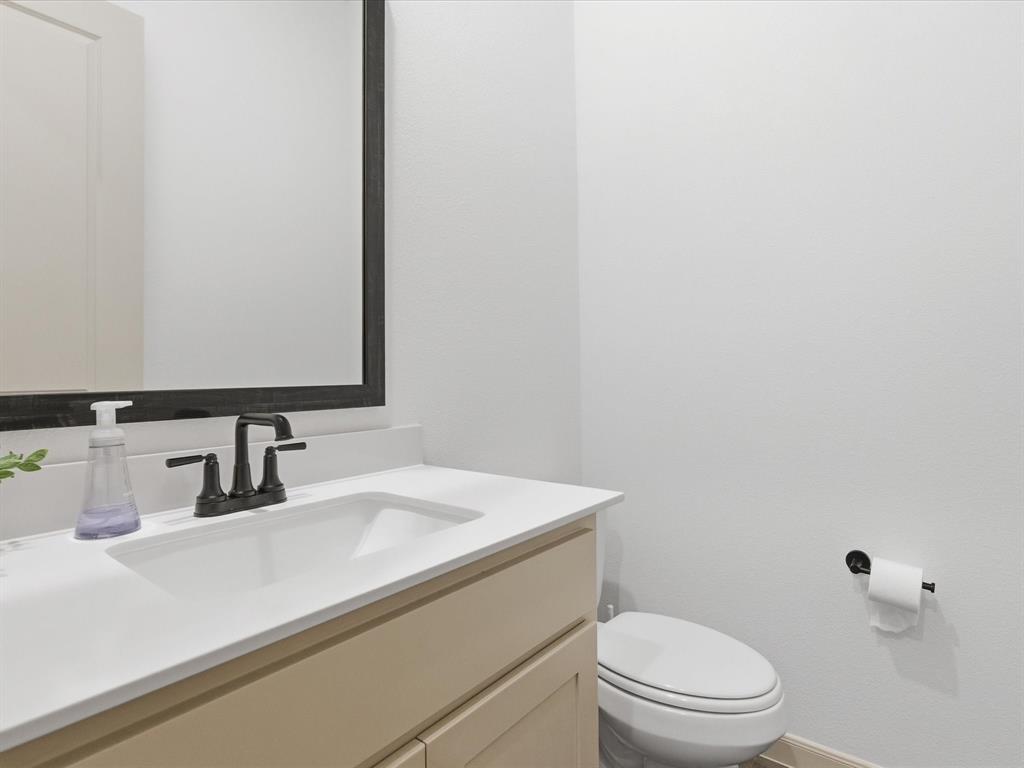 9533 Keep Street Frisco, TX 75035 - Photo 22 of 40 Modern vanity featuring a beige cabinet, white countertop, and integrated sink