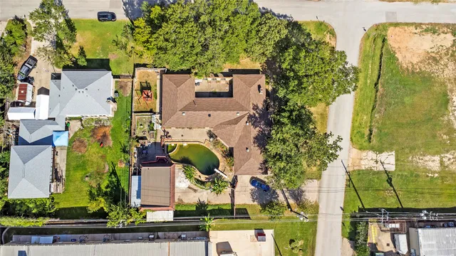 an aerial view of a house with a garden and swimming pool