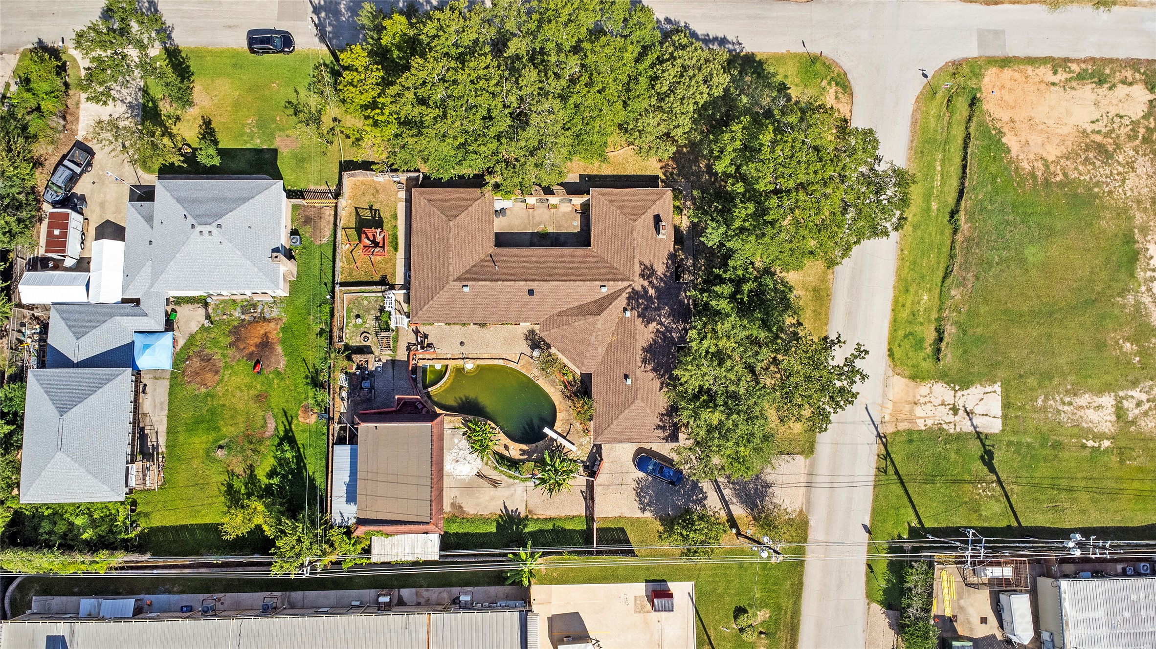 an aerial view of a house with a garden and swimming pool