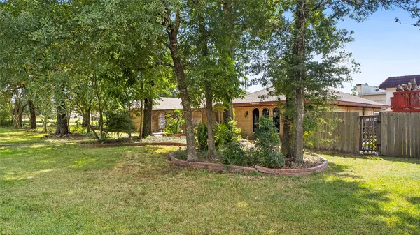 a view of a house with a yard and tree s