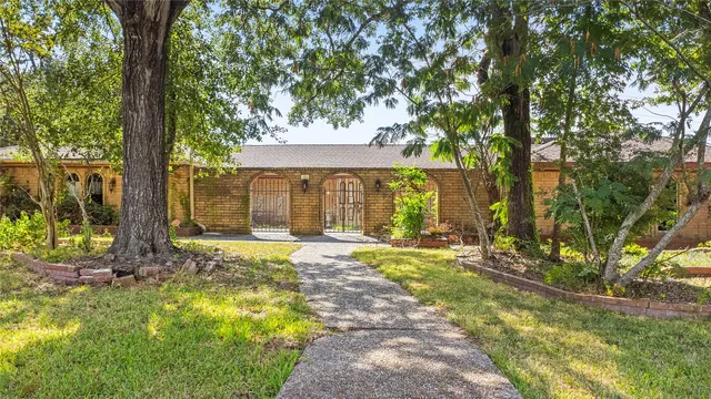 a view of a house with backyard and sitting area