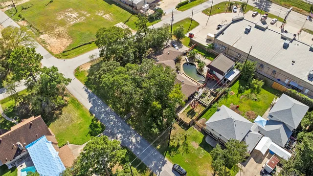 an aerial view of a house with a yard and greenery