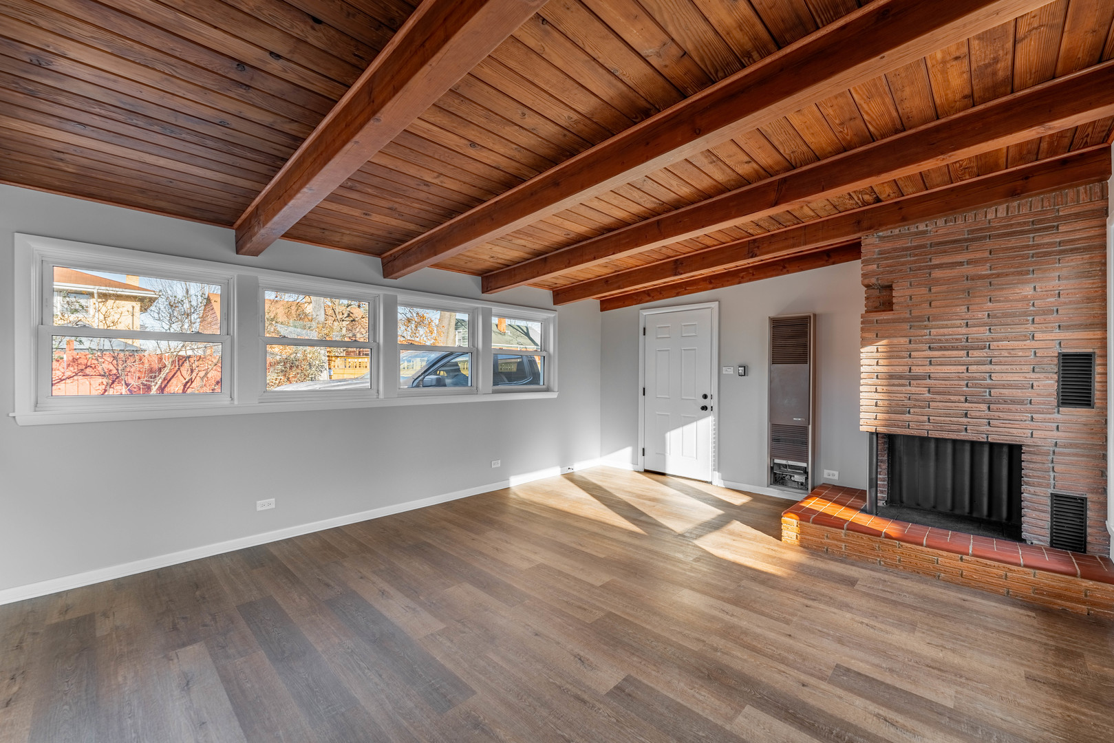 3615 Raymond Avenue Brookfield, IL 60513 - Photo 22 of 49 a view of an empty room with wooden floor and a fireplace