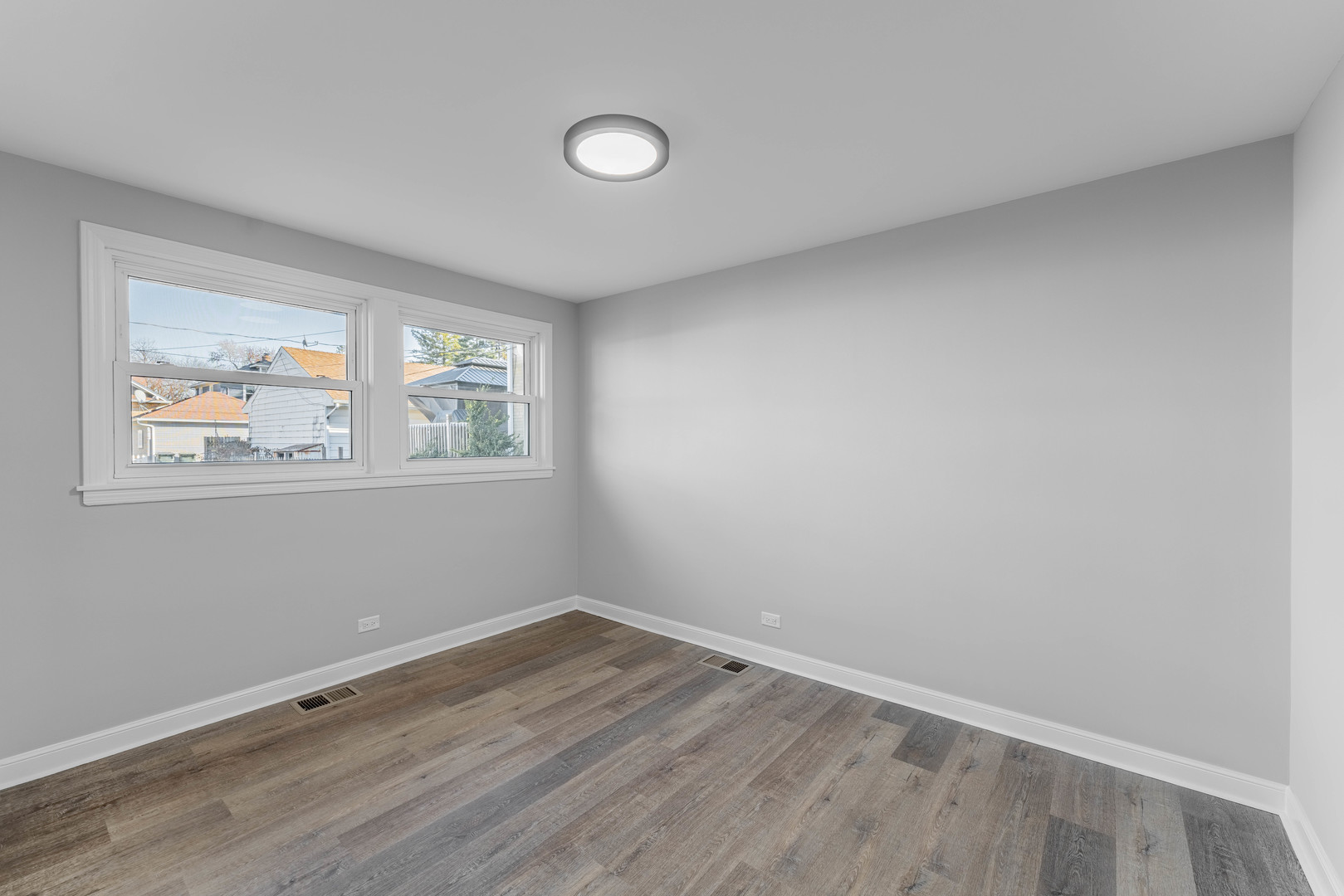3615 Raymond Avenue Brookfield, IL 60513 - Photo 34 of 49 a view of an empty room with wooden floor and a window