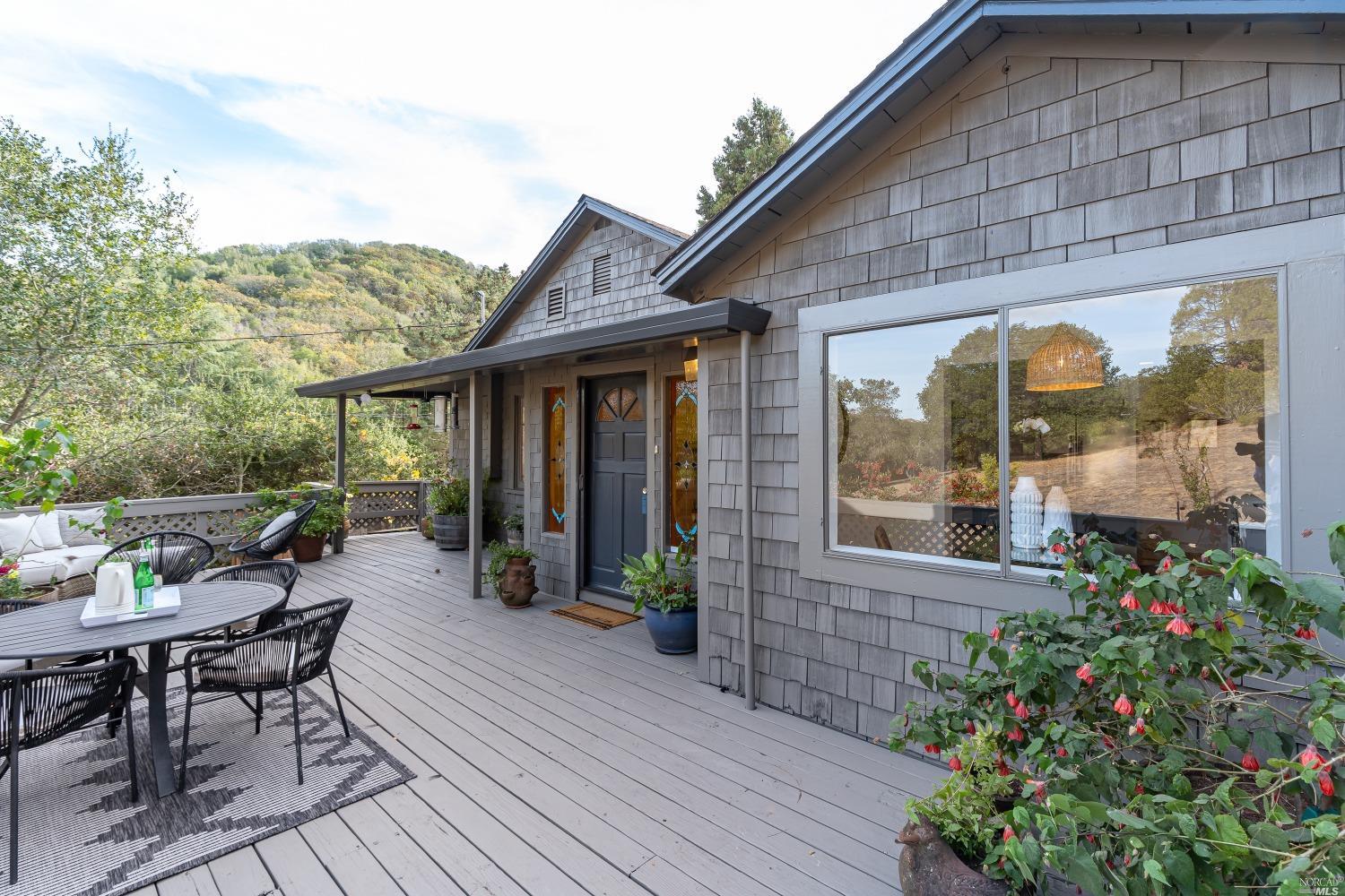 a view of a house with backyard sitting area and garden