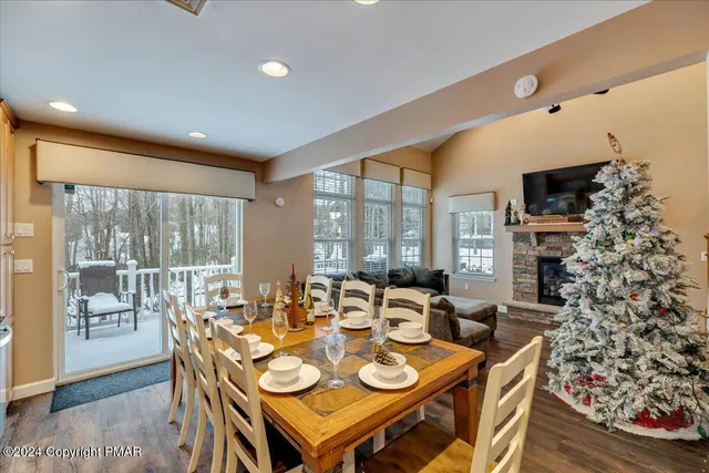a view of a dining room with furniture large windows and wooden floor