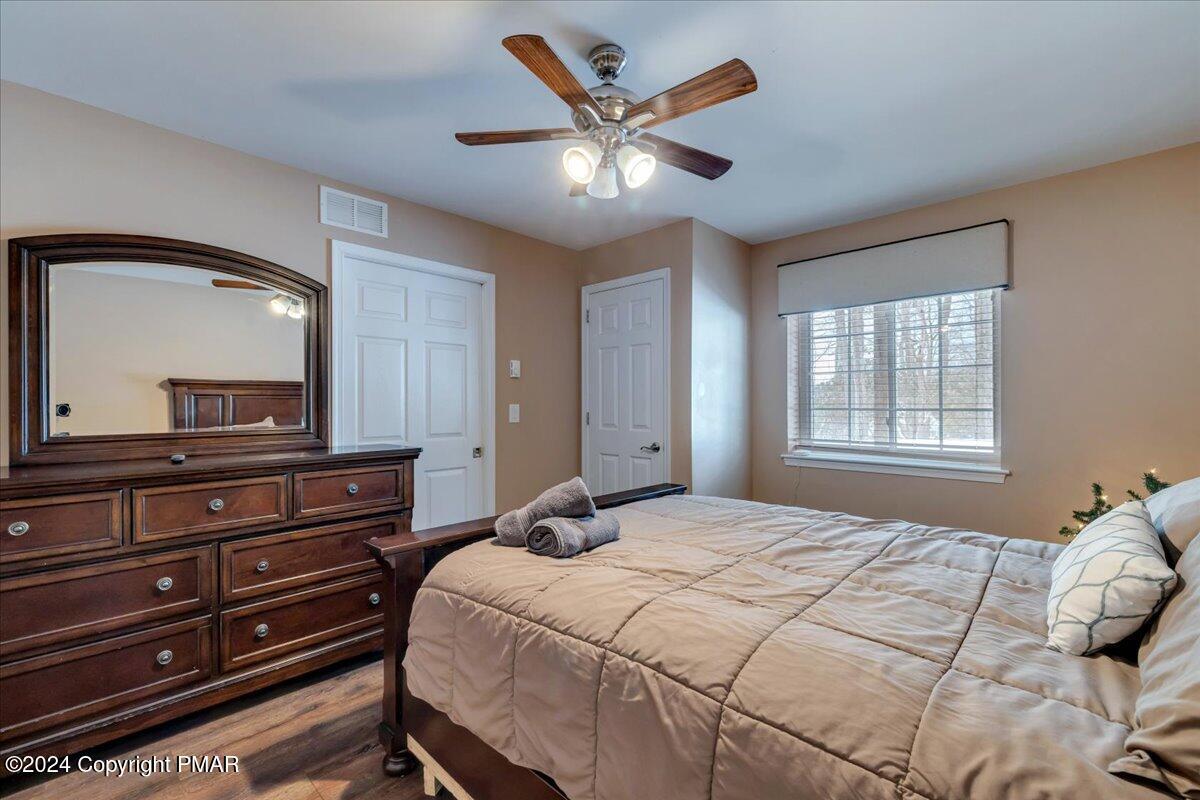 12 Beechwood Road Lake Harmony, PA 18624 - Photo 13 of 45 a bedroom with a large bed and a large mirror