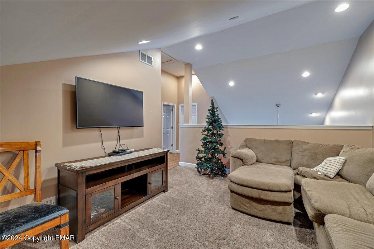 12 Beechwood Road Lake Harmony, PA 18624 - Photo 20 of 45 a living room with furniture and a flat screen tv