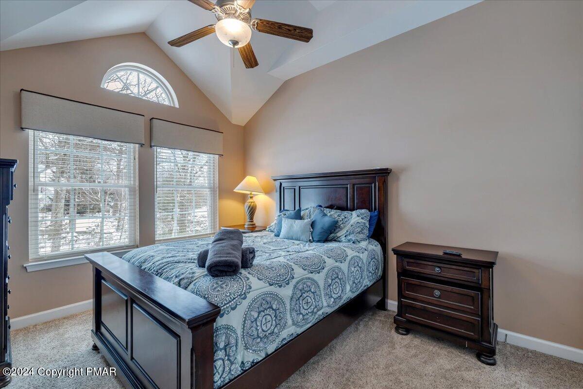 12 Beechwood Road Lake Harmony, PA 18624 - Photo 22 of 45 a bedroom with a bed and a chandelier