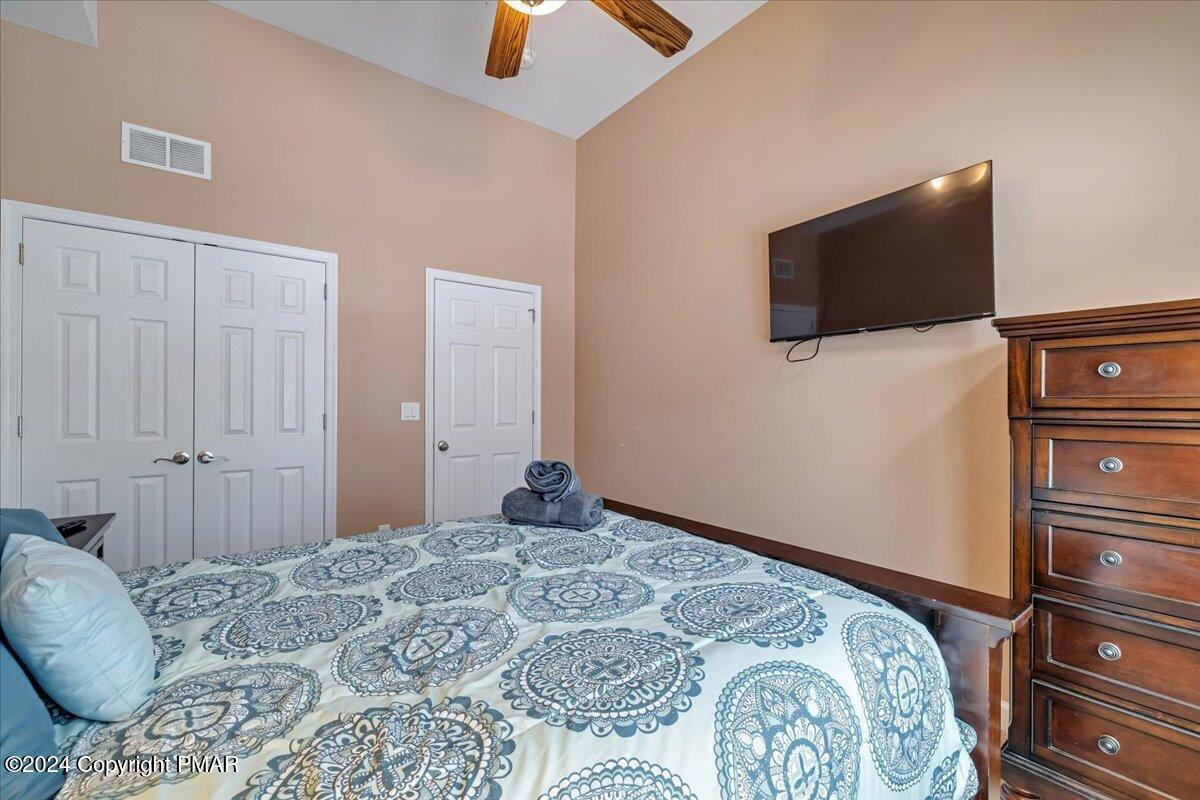 12 Beechwood Road Lake Harmony, PA 18624 - Photo 23 of 45 a bedroom with a bed and a flat screen tv