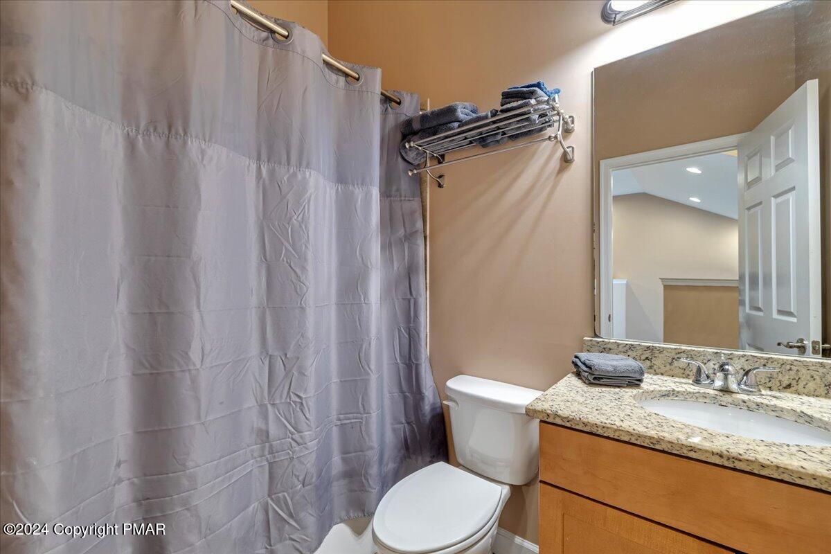 12 Beechwood Road Lake Harmony, PA 18624 - Photo 25 of 45 a bathroom with a granite countertop sink toilet and shower