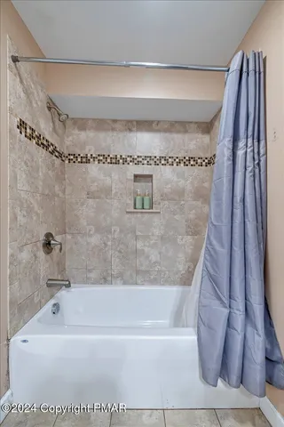 a view of a livingroom with furniture and chandelier fan