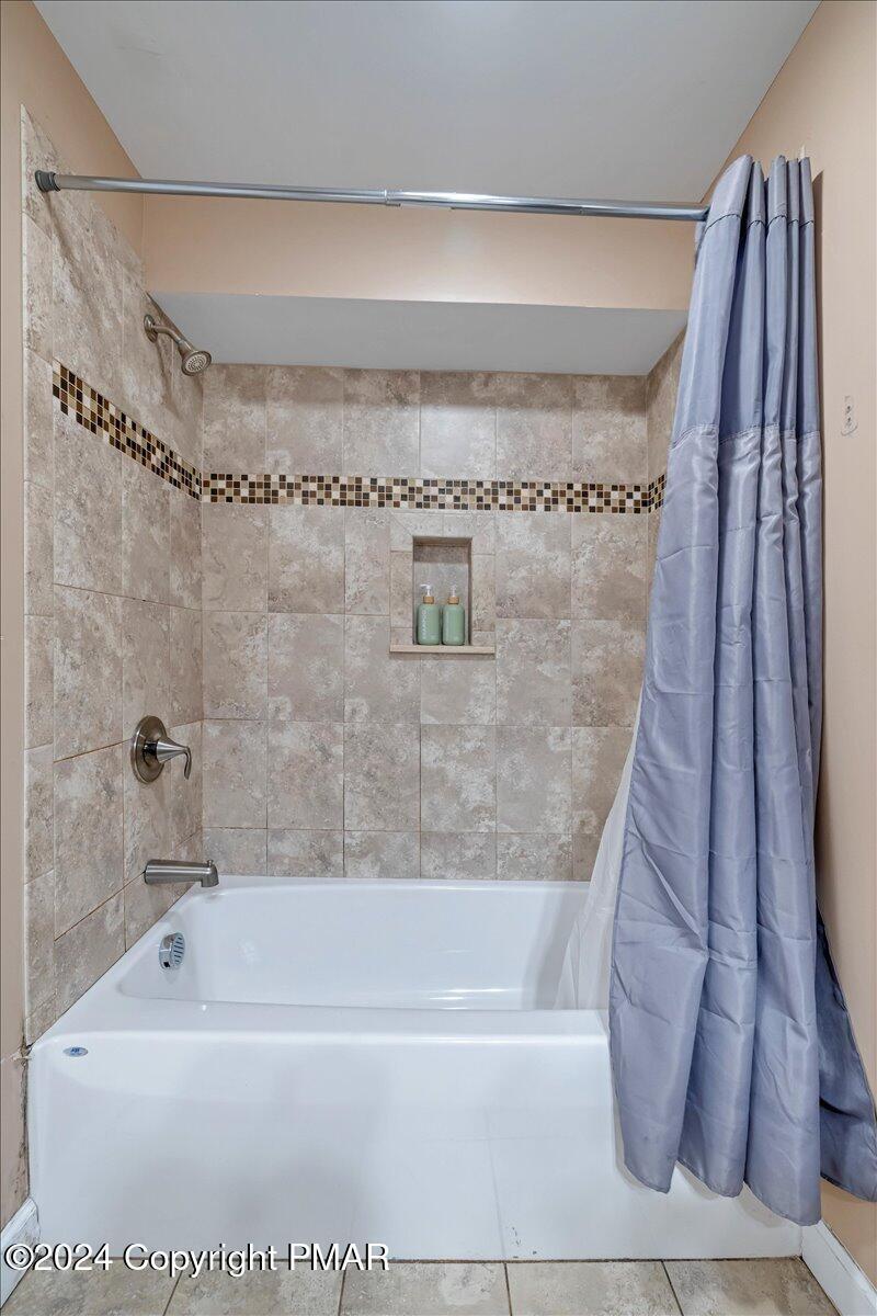 12 Beechwood Road Lake Harmony, PA 18624 - Photo 31 of 45 a bathroom with a bathtub and a shower