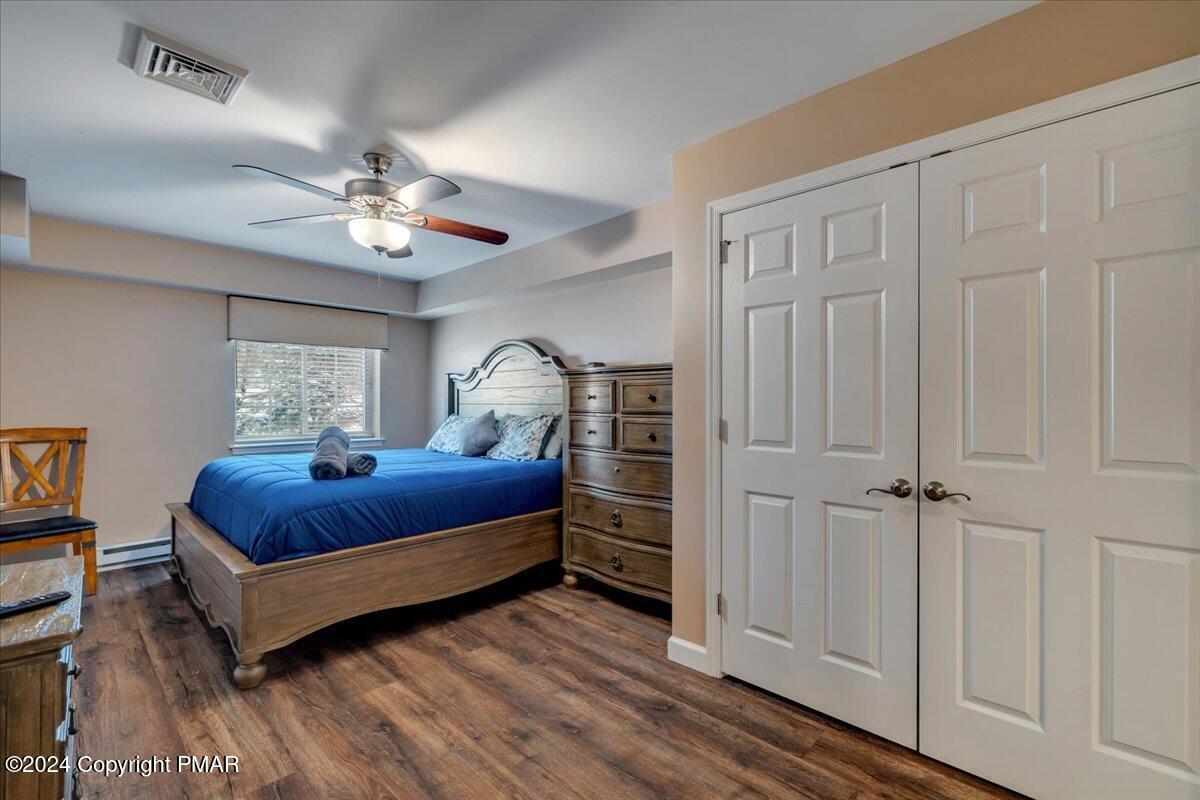 12 Beechwood Road Lake Harmony, PA 18624 - Photo 32 of 45 a bedroom with a bed chandelier and a window