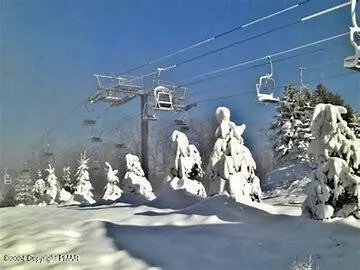 a view of house with outdoor space and sitting area