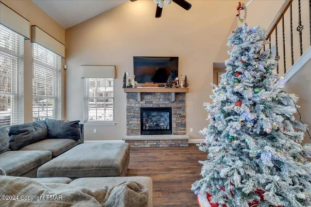 a living room with a fireplace and a flat screen tv