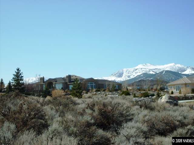 a view of a town with mountains in the background