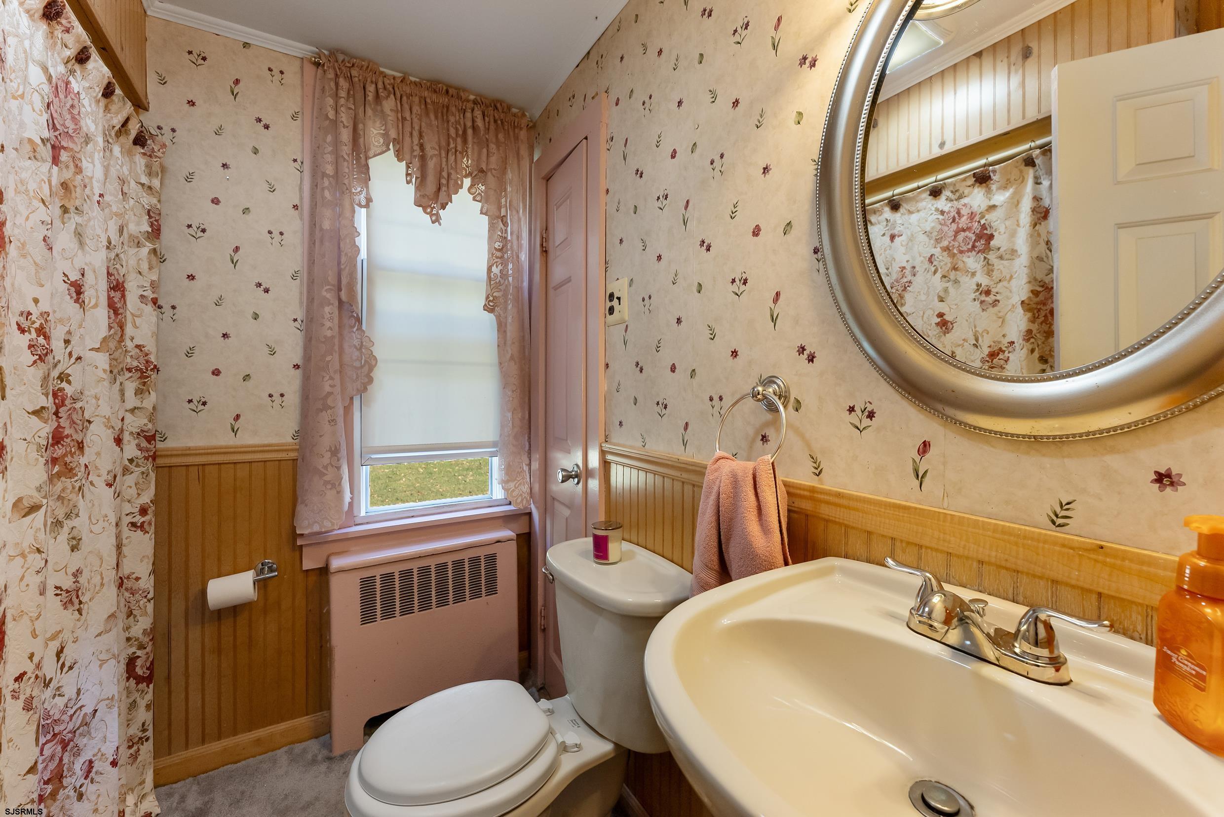 225 Chestnut Neck Road Port Republic, NJ 08241 - Photo 11 of 29 a bathroom with a sink and a mirror