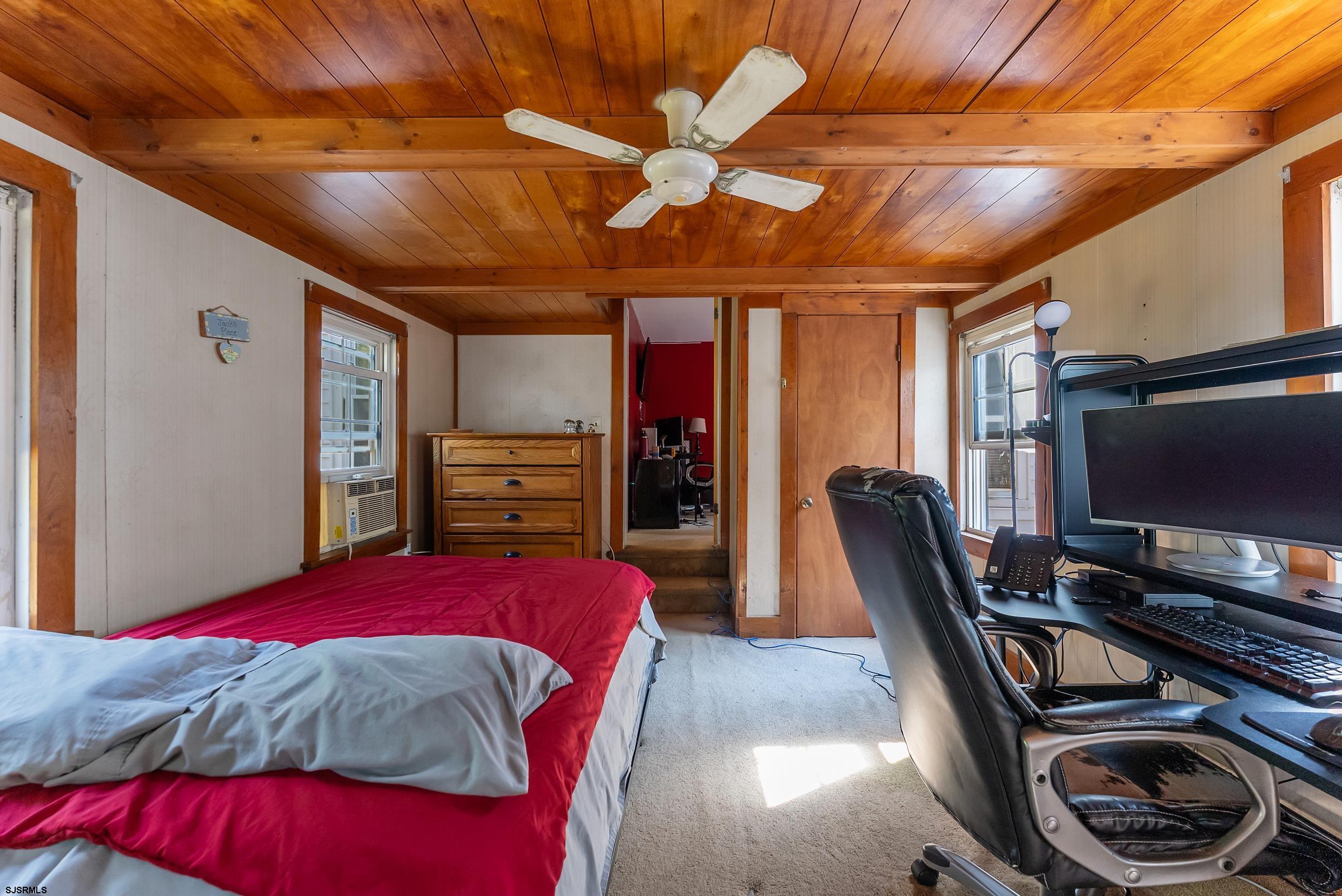 225 Chestnut Neck Road Port Republic, NJ 08241 - Photo 15 of 29 a bed room with a bed and a flat screen tv