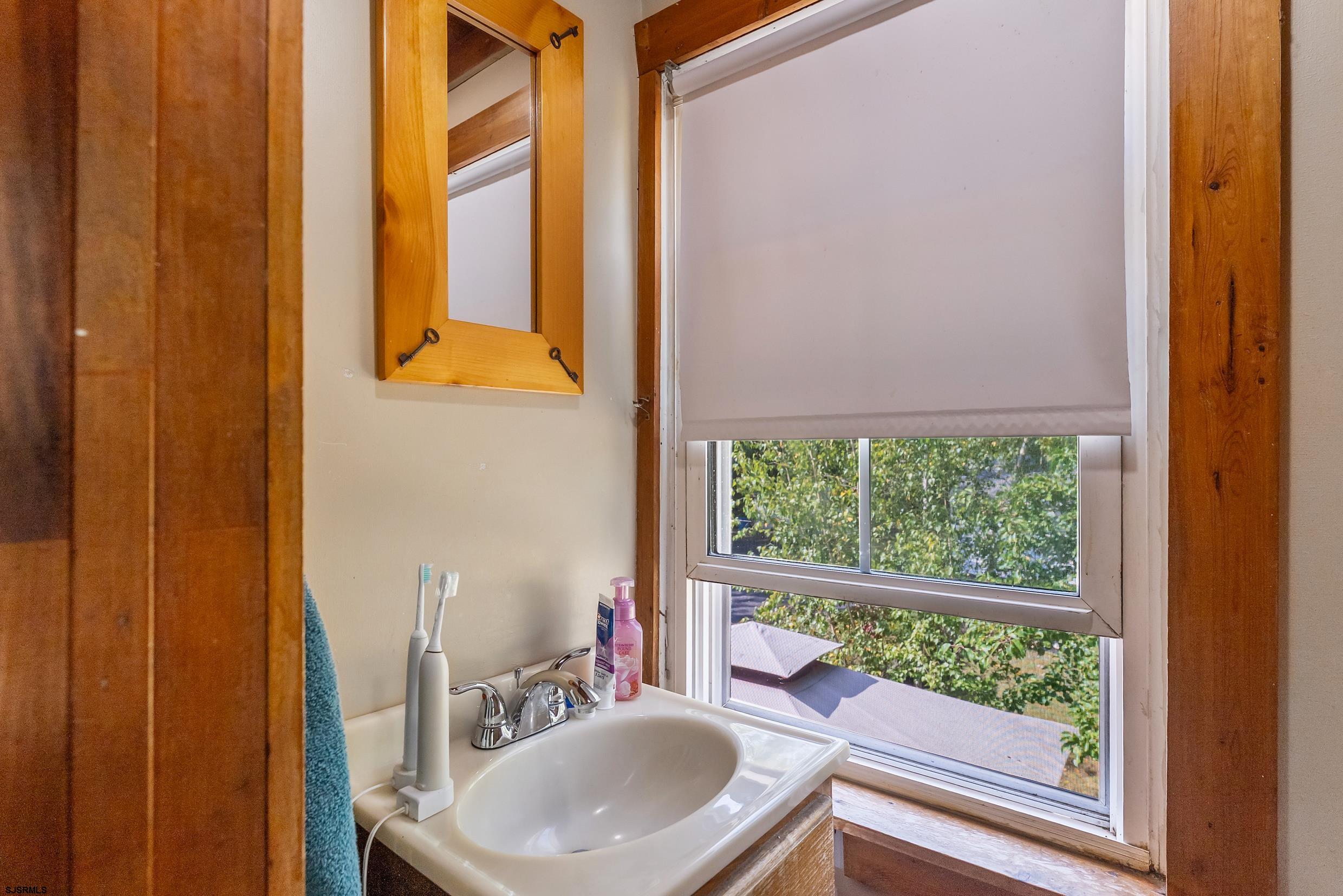 225 Chestnut Neck Road Port Republic, NJ 08241 - Photo 16 of 29 a bathroom with a sink and a mirror