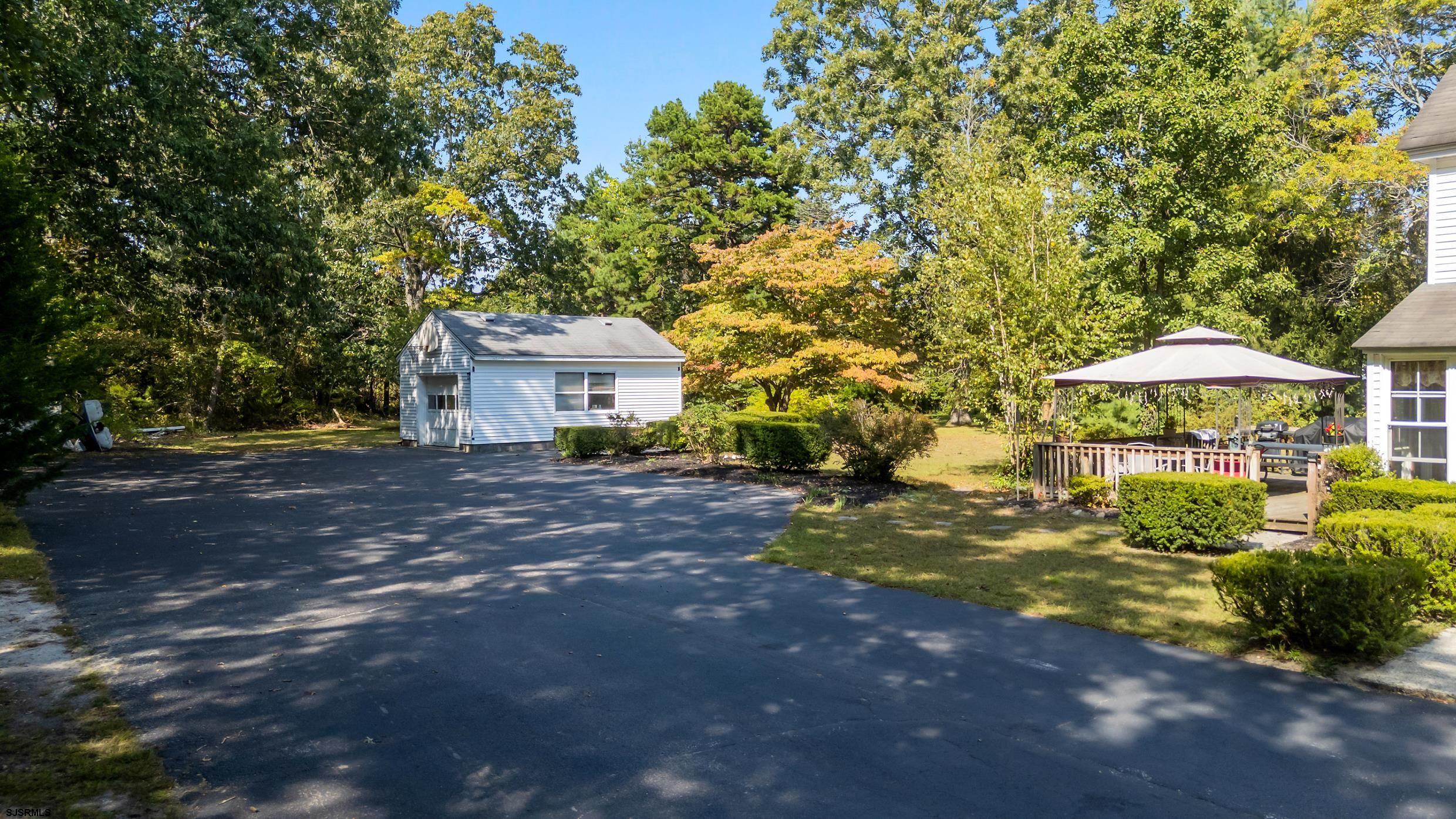225 Chestnut Neck Road Port Republic, NJ 08241 - Photo 25 of 29 a front view of a house with garden