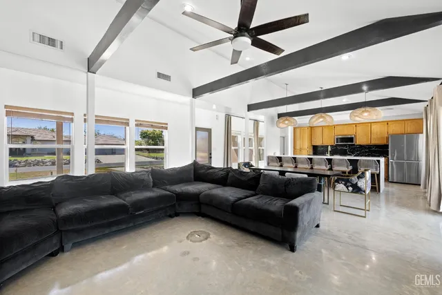 a dining room with wooden floor a chandelier a wooden table and chairs