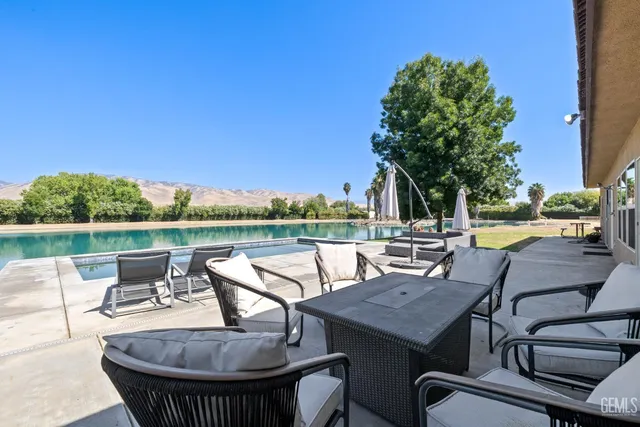 a view of a lake with a yard and a mountain view
