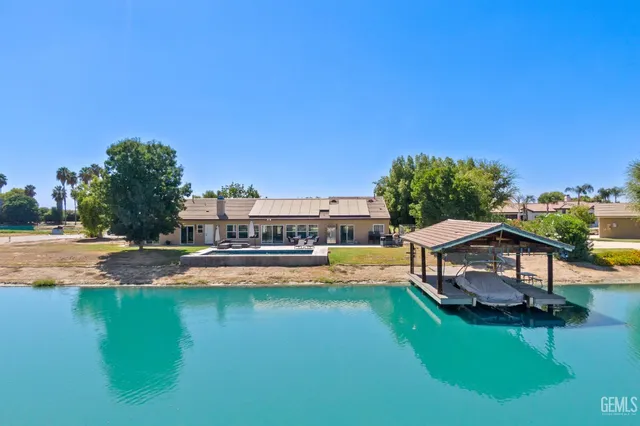 a house with swimming pool in front of it