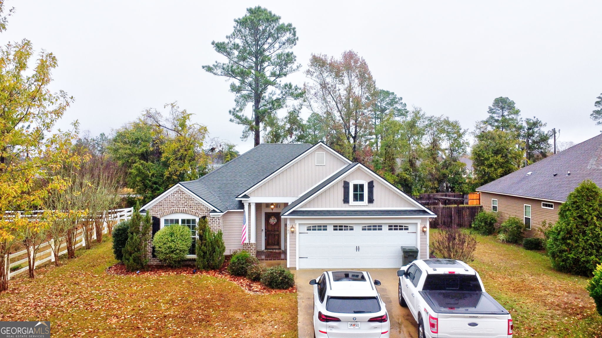 an aerial view of a house with a yard