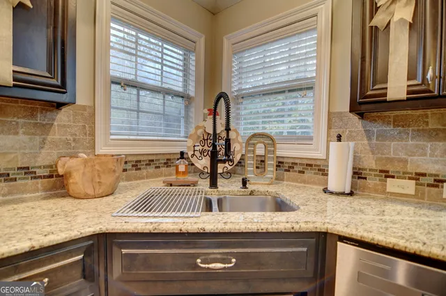 a kitchen with granite countertop a sink and a window
