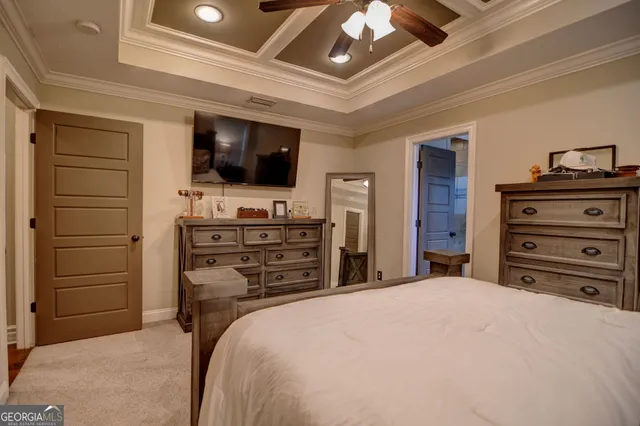 a bedroom with a bed and a television