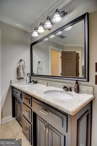 a bathroom with a granite countertop sink a large mirror and a vanity