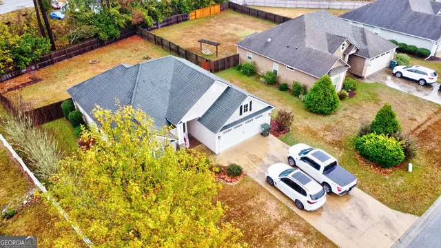an aerial view of a house with garden space and street view