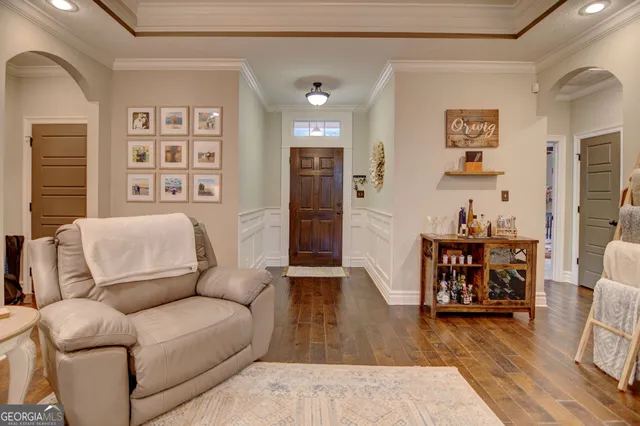 a living room with furniture and wooden floor