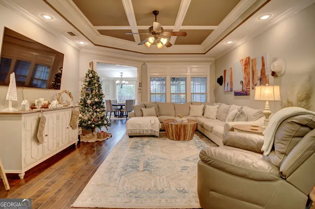 a living room with furniture and a chandelier