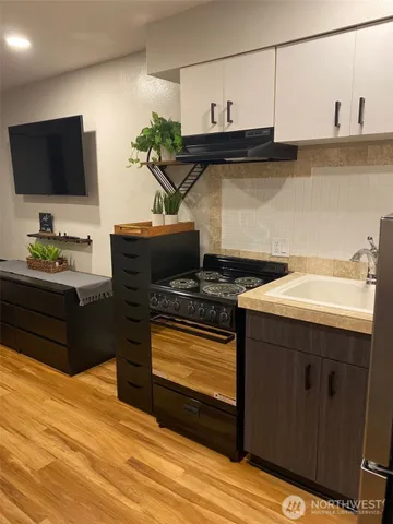 a kitchen with a sink and cabinets