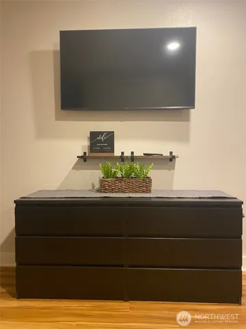 a view of a hardwood floor and wardrobe