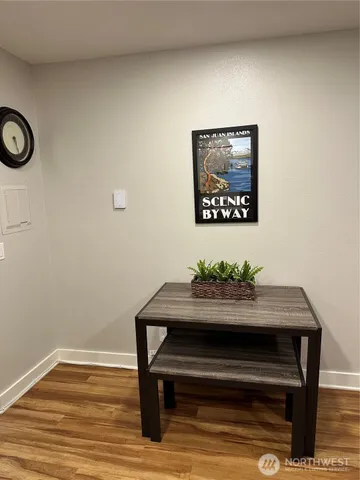 a view of a hallway with wooden floor