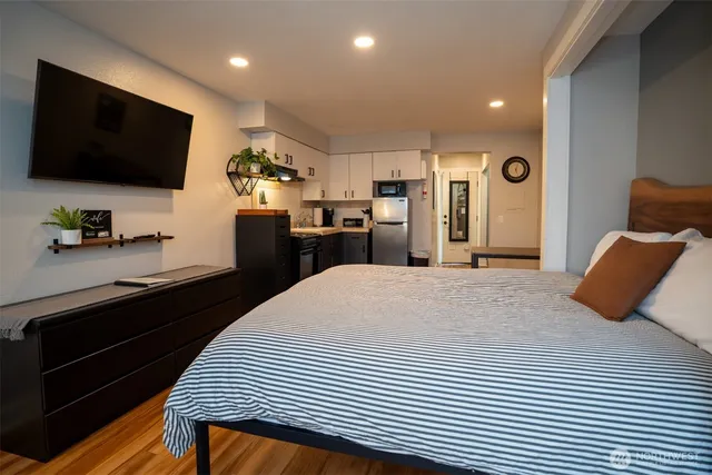 a bedroom with a bed and a flat screen tv