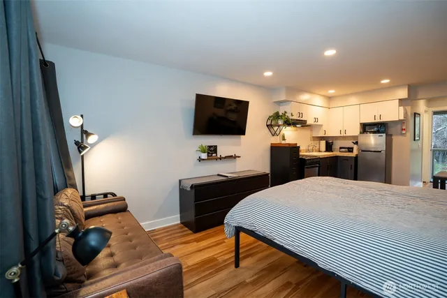 a kitchen with a table chairs refrigerator and a stove