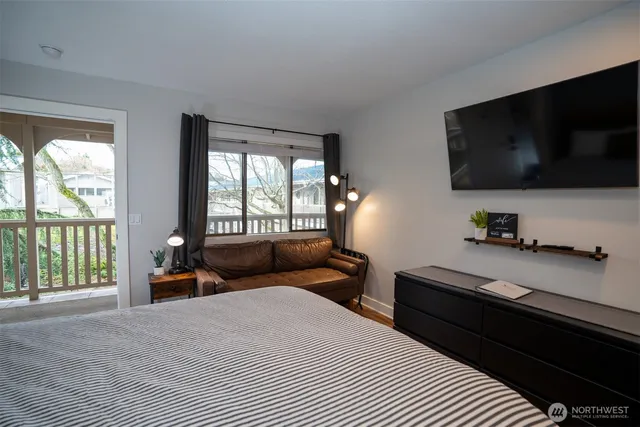 a bedroom with a bed and flat screen tv