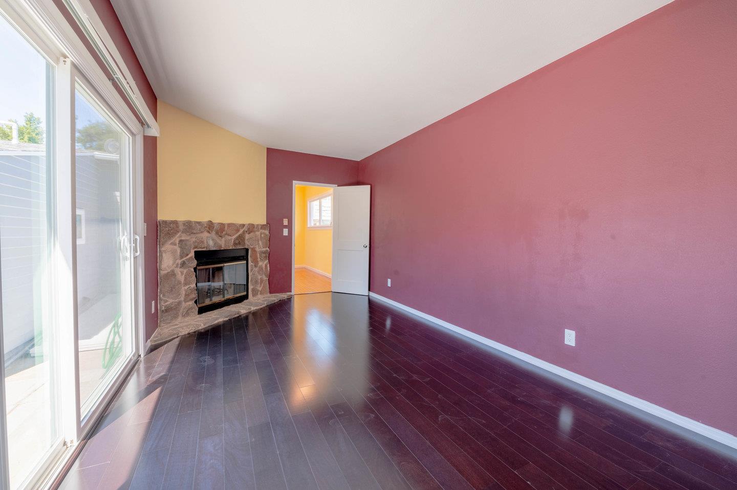271 Everett Avenue Campbell, CA 95008 - Photo 17 of 32 a view of an empty room with a fireplace and a window