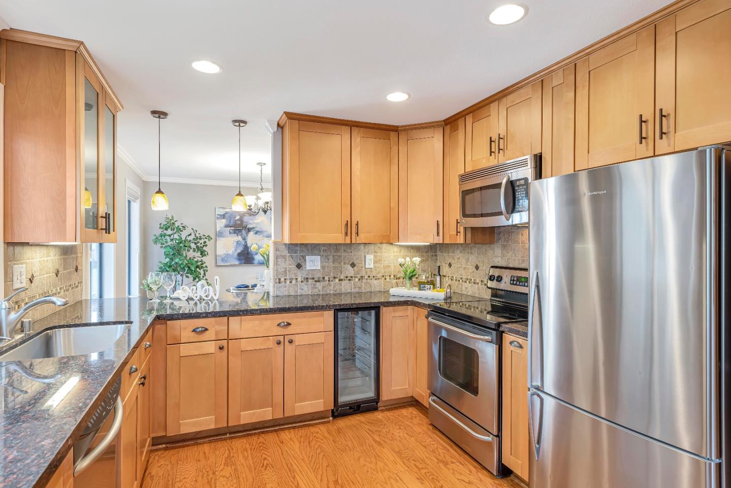 47 Dot Avenue, Unit A Campbell, CA 95008 - Photo 12 of 31 a kitchen with stainless steel appliances granite countertop a refrigerator sink and cabinets